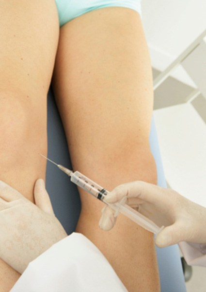 Patient receiving injection in knee joint