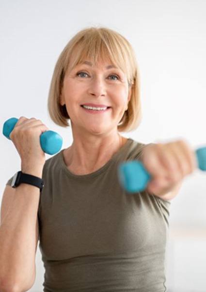 Senior woman exercising with small dumbbells