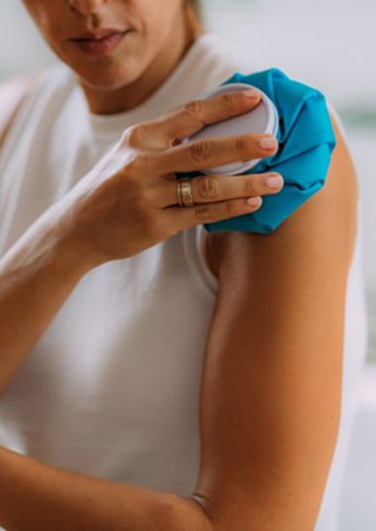 Woman applying ice to her shoulder