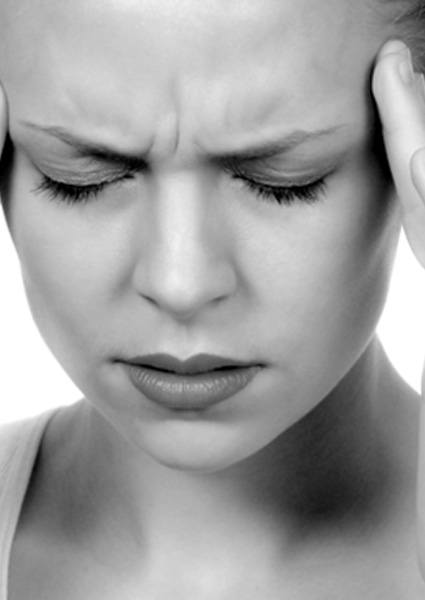 Black and white photo of woman with headache