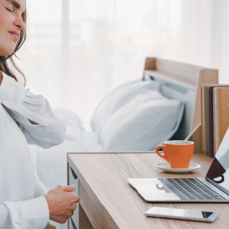 Woman holding neck before integrative pain management