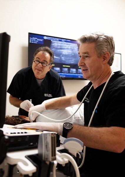 Doctors performing ultrasound guided joint and nerve blocks