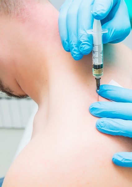 Doctor providing trigger point injection for pain management