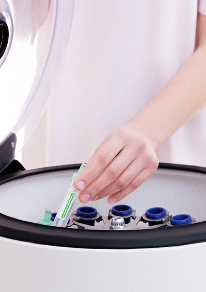 doctor pulling PRP out of a centrifuge 