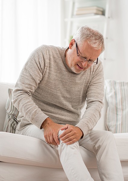 Doctor administering knee injection